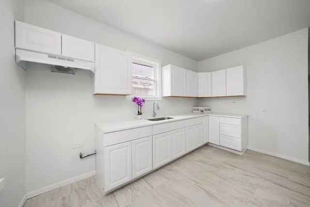 a kitchen with sink cabinets and window