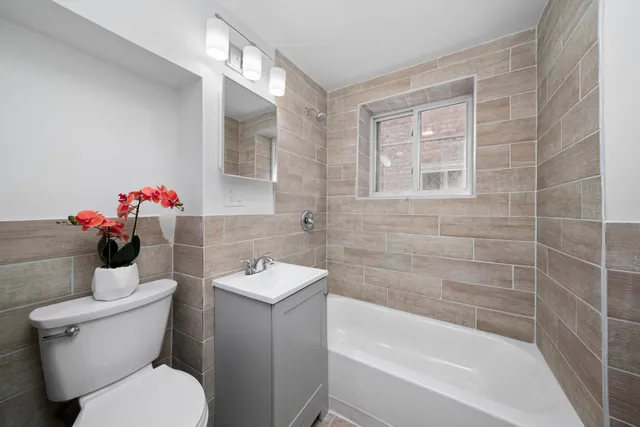 a white toilet sitting next to a bath tub and shower