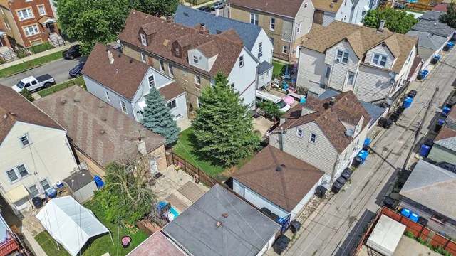 an aerial view of multiple houses with a yard