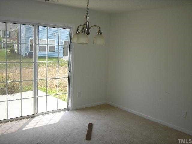6004 Namozine Court Raleigh, NC 27610 - Photo 4 of 12 an empty room with a empty space and windows