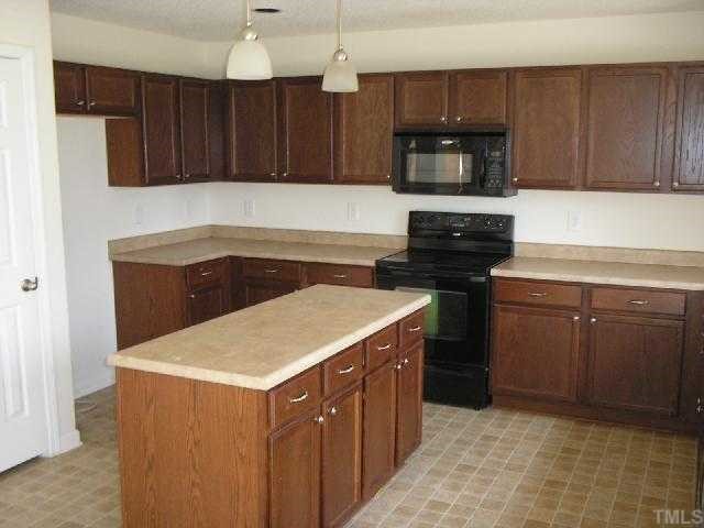 6004 Namozine Court Raleigh, NC 27610 - Photo 5 of 12 a kitchen with a cabinets and steel stove