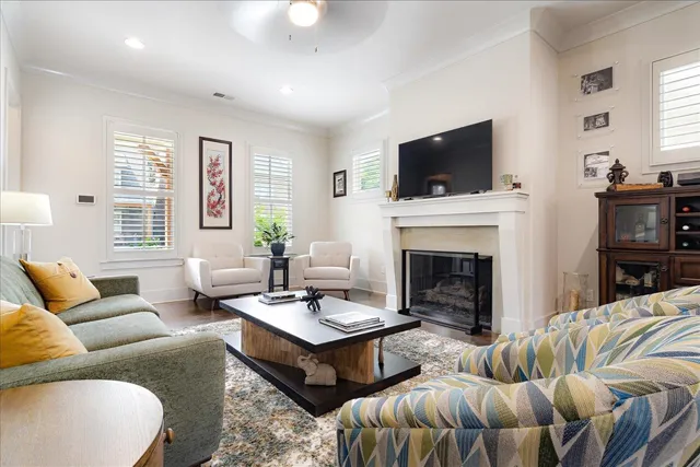 a living room with furniture a flat screen tv and a fireplace