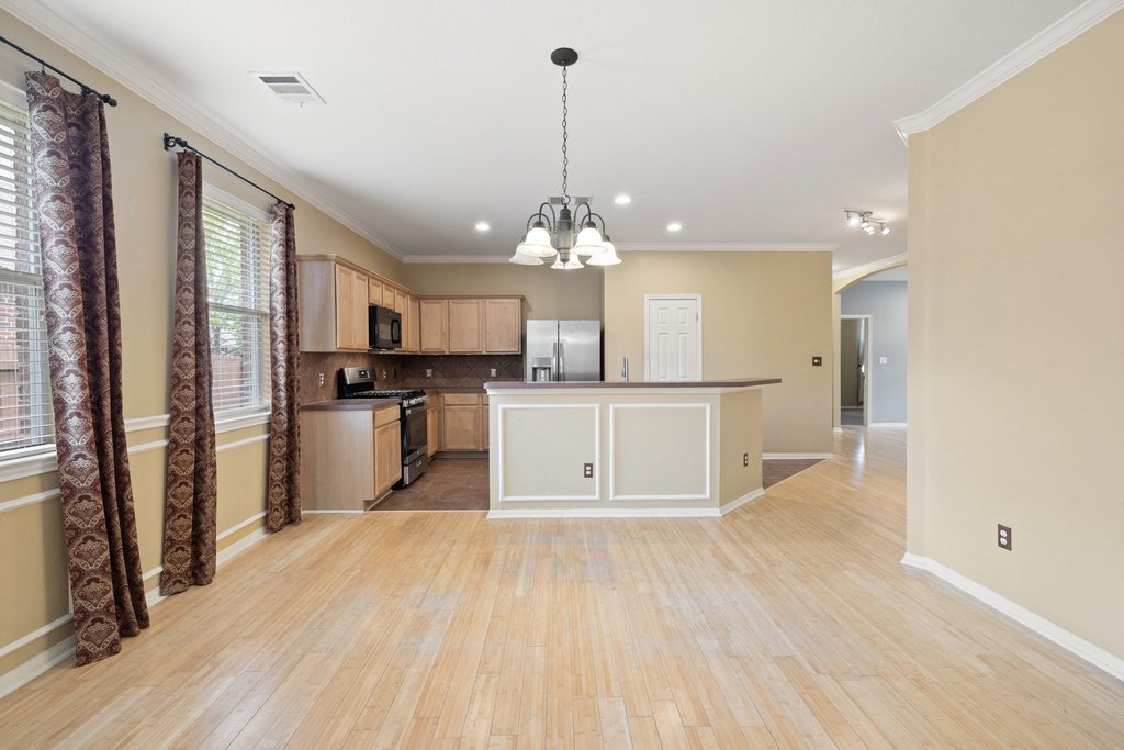 347 Spring Drive Kyle, TX 78640 - Photo 18 of 40 An open-concept living space presents a well-appointed kitchen with an inviting breakfast bar.