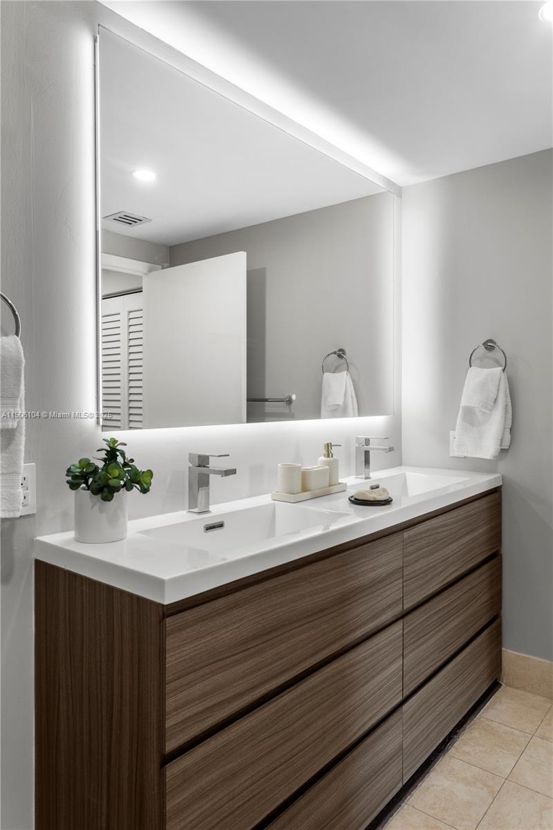 2475 Brickell Avenue, Unit 708 Miami, FL 33129 - Photo 12 of 21 a bathroom with a sink and a mirror
