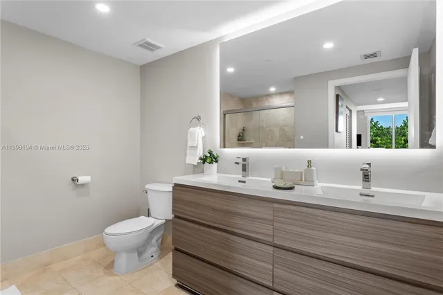 a bathroom with a toilet a sink and mirror