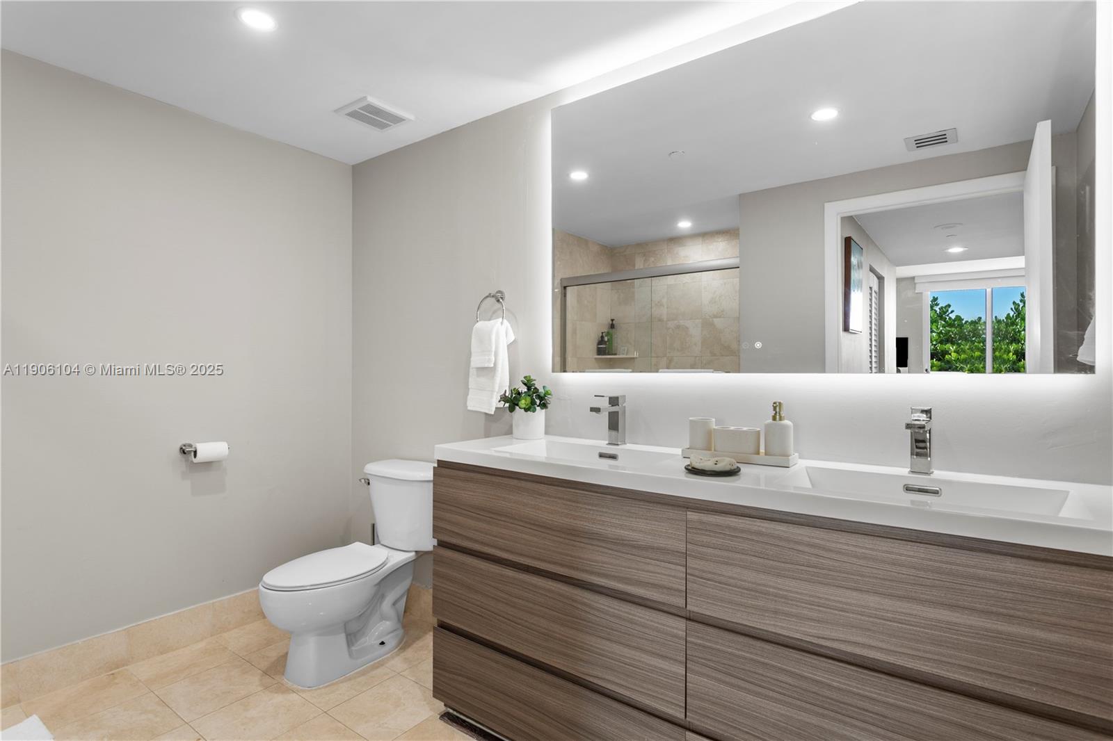 2475 Brickell Avenue, Unit 708 Miami, FL 33129 - Photo 14 of 21 a bathroom with a toilet a sink and mirror