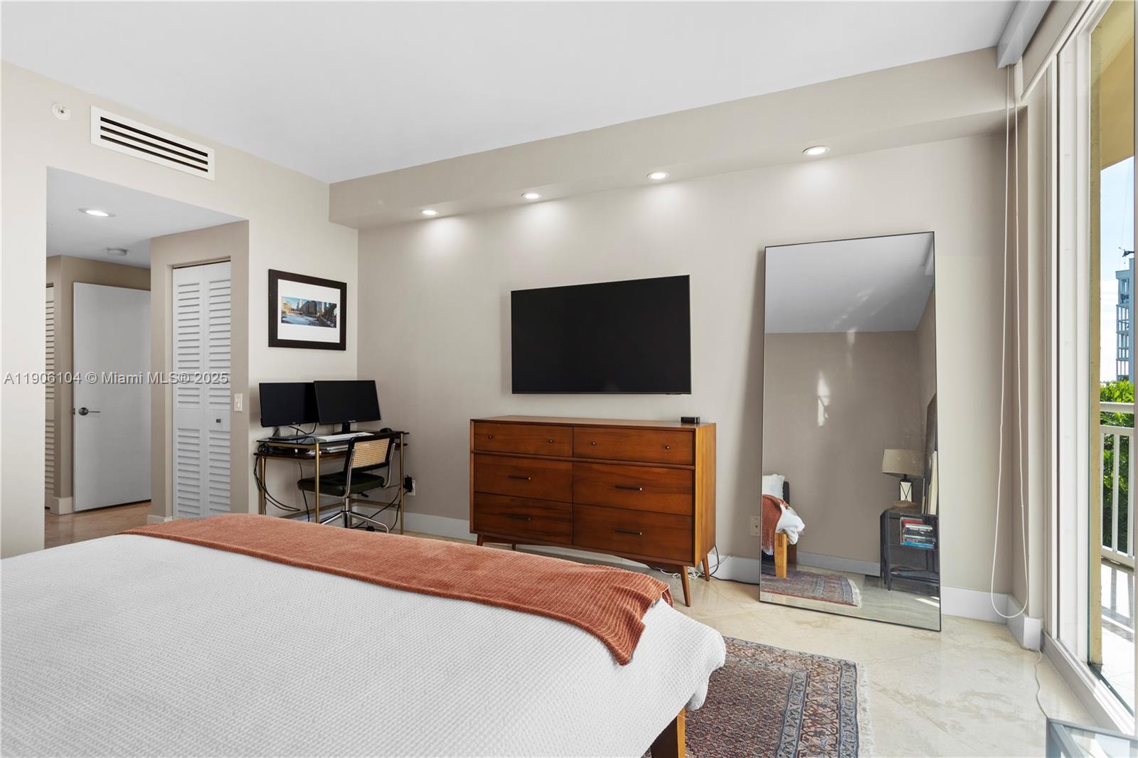 2475 Brickell Avenue, Unit 708 Miami, FL 33129 - Photo 15 of 21 a bedroom with a bed and a flat screen tv