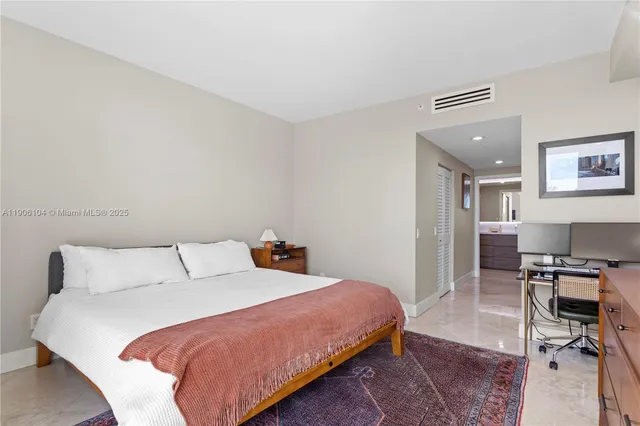 a bedroom with a bed a desk and chair