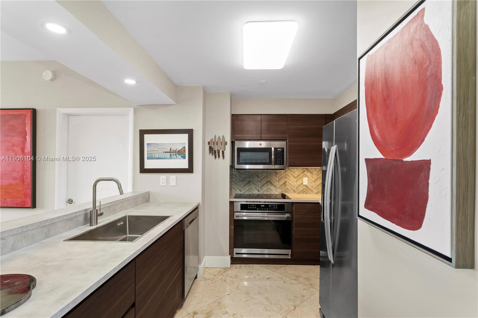 2475 Brickell Avenue, Unit 708 Miami, FL 33129 - Photo 8 of 21 a kitchen with stainless steel appliances granite countertop a sink stove and refrigerator