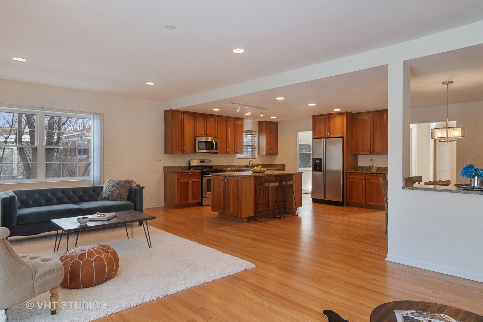 2422 Central Road Glenview, IL 60025 - Photo 8 of 18 a kitchen with stainless steel appliances granite countertop a refrigerator a stove top oven a sink a dining table and chairs with wooden floor
