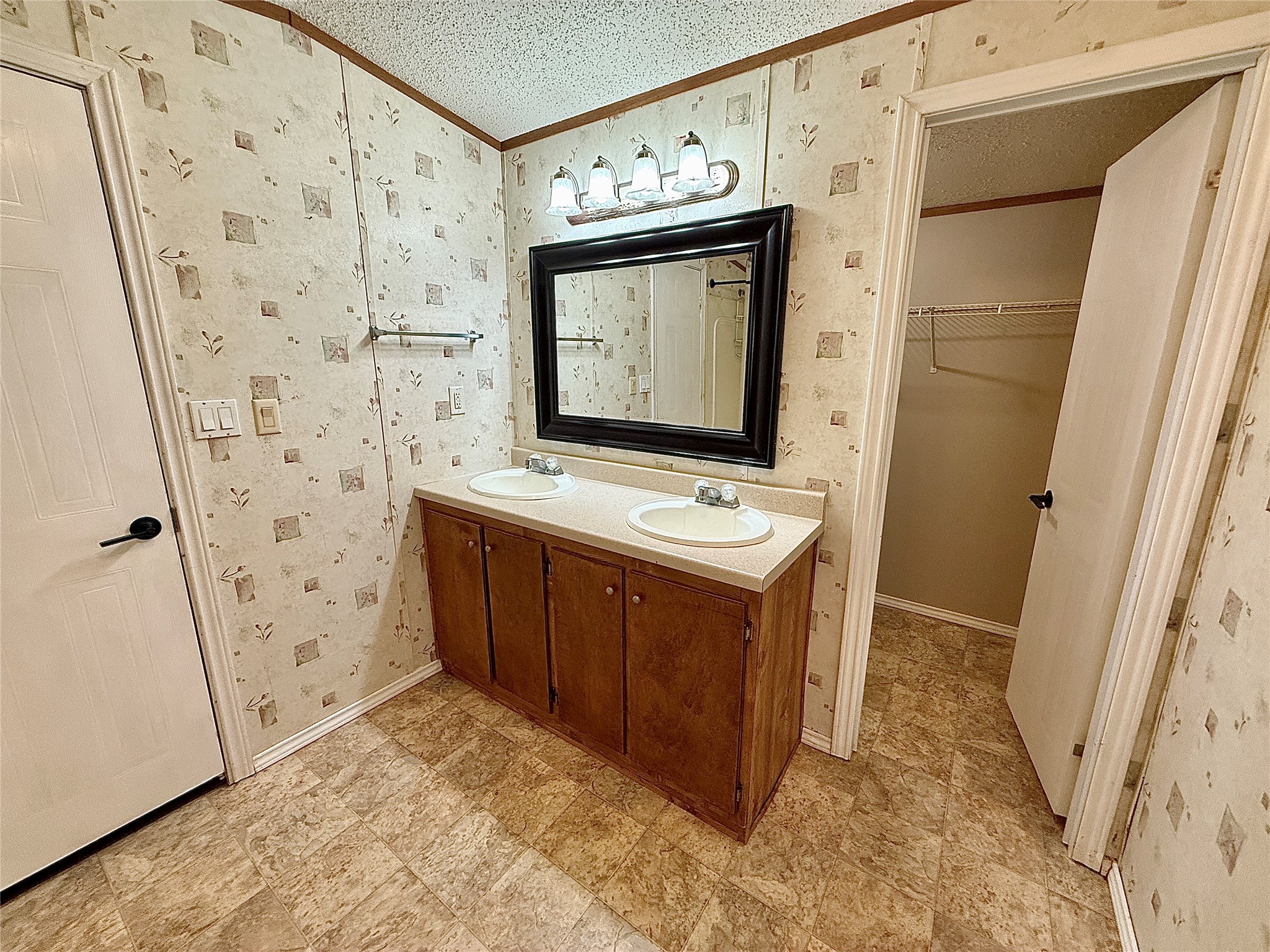 3075 FM 2001 Buda, TX 78610 - Photo 15 of 26 Dual vanity sinks and generous storage offer practicality in this well-appointed bathroom.