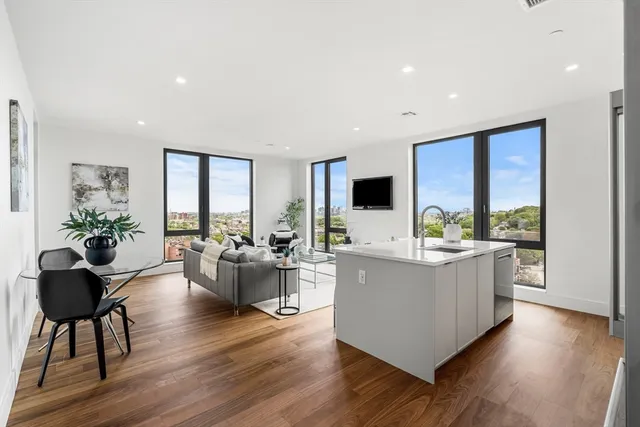 a living room with furniture and large windows
