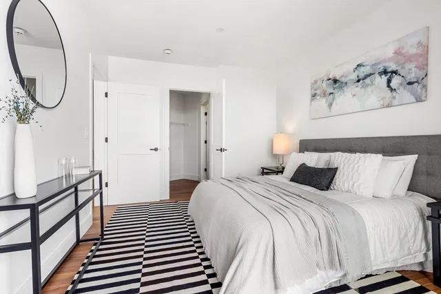 a bedroom with a bed and a mirror