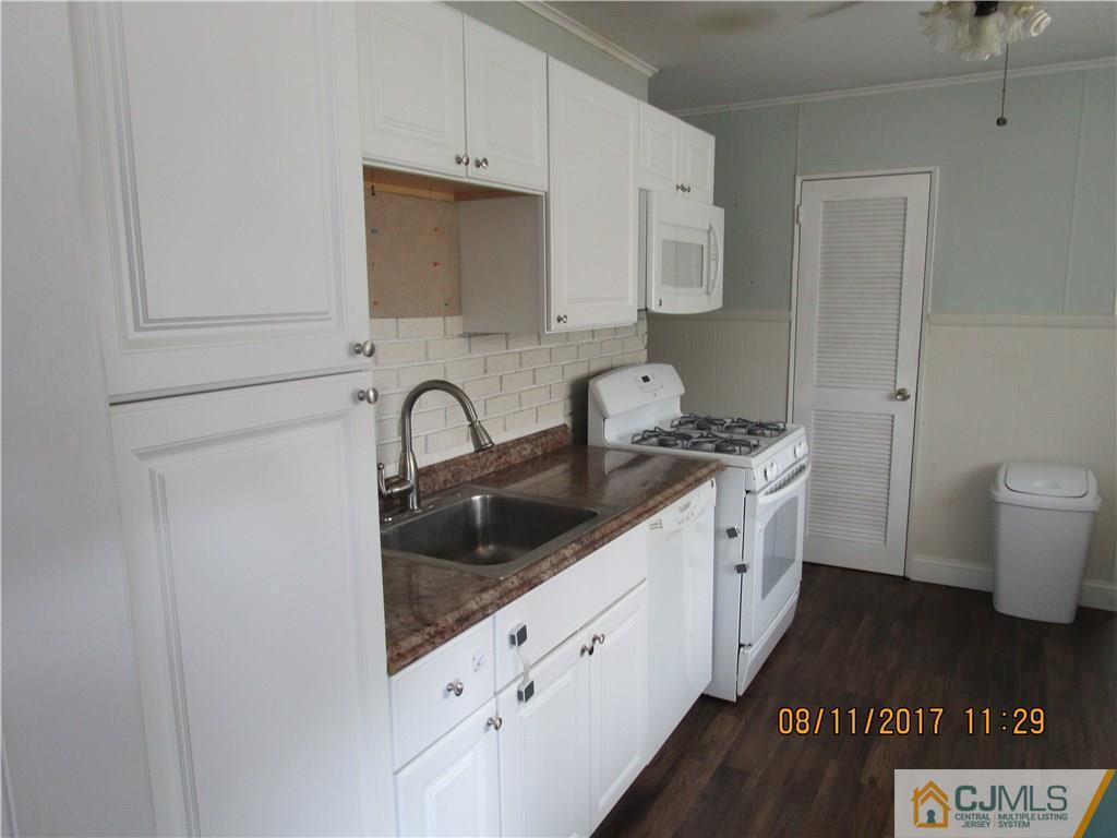 33 Winthrop Road Edison, NJ 08817 - Photo 8 of 23 a kitchen with granite countertop a sink a stove and cabinets