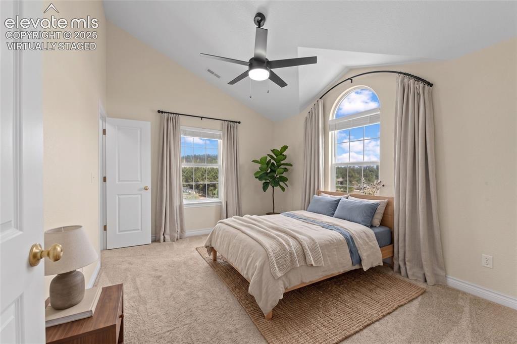 16540 Mesquite Road Peyton, CO 80831 - Photo 21 of 50 a bedroom with a large bed and a window
