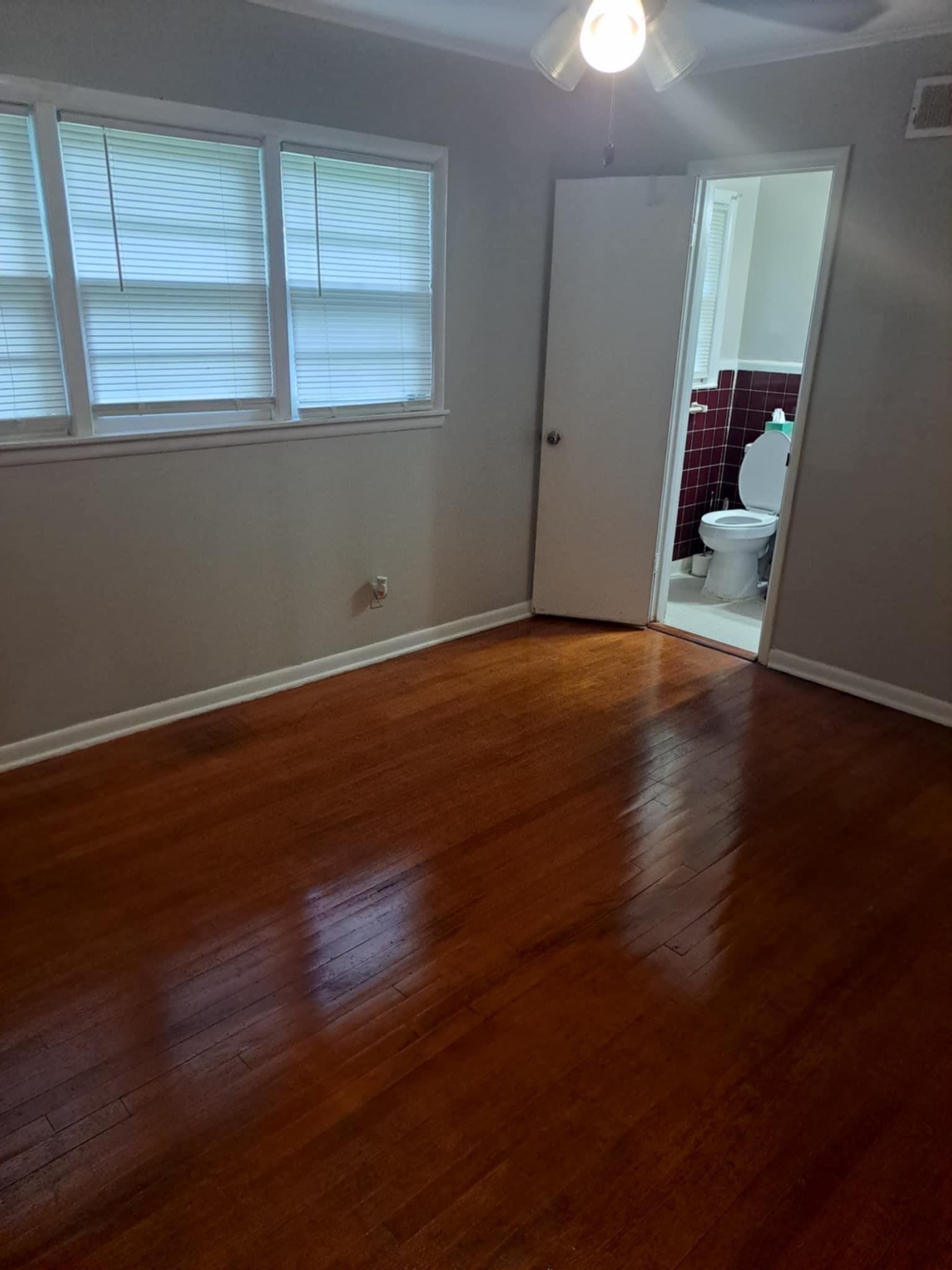1351 Janis Drive Memphis, TN 38116 - Photo 18 of 27 Unfurnished bedroom featuring a ceiling fan, dark wood-type flooring, and ensuite bathroom