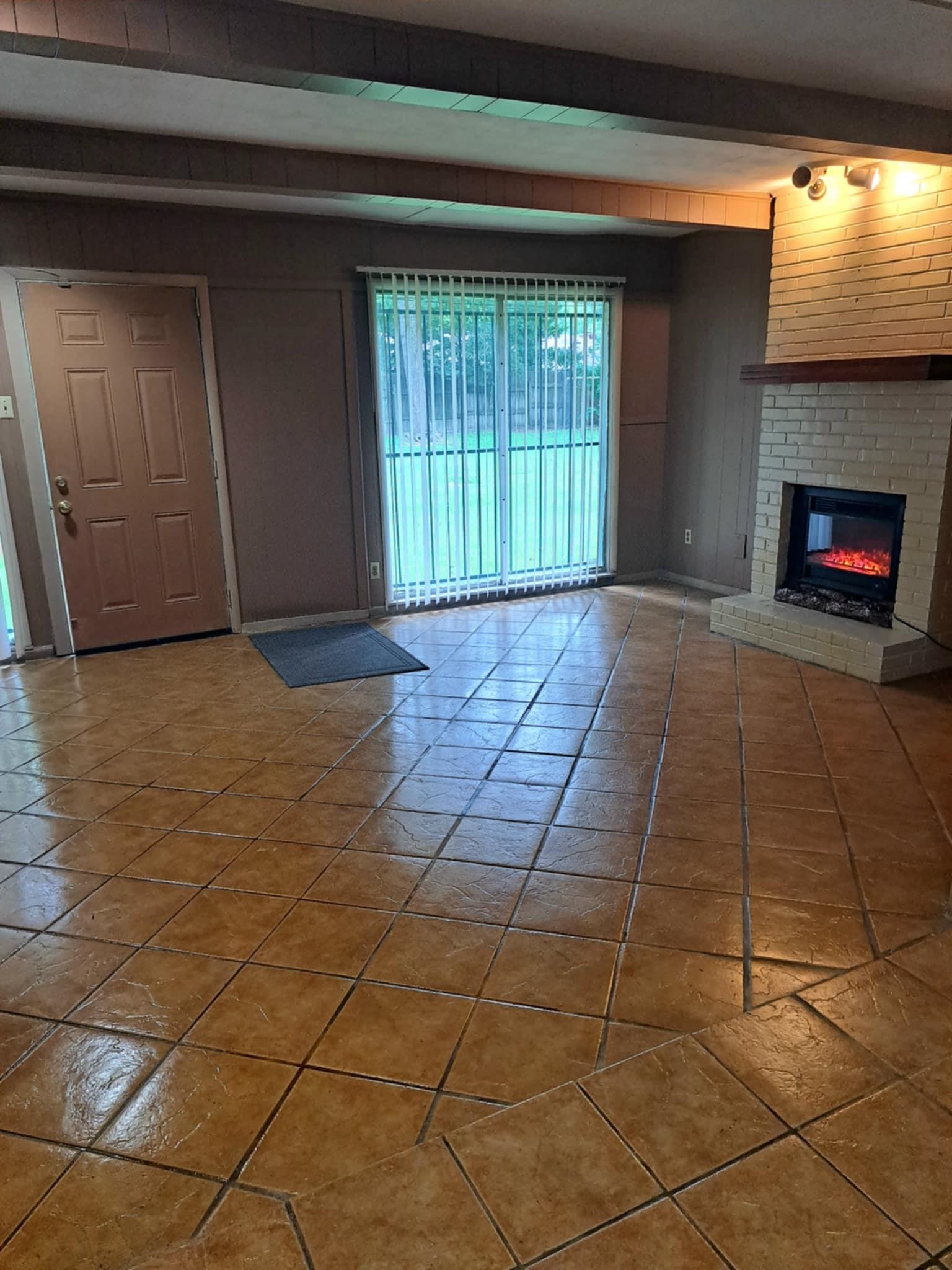 1351 Janis Drive Memphis, TN 38116 - Photo 6 of 27 Unfurnished living room featuring a brick fireplace and wood walls