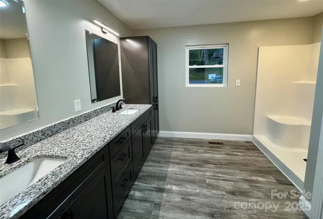 a bathroom with a granite countertop sink a mirror and a