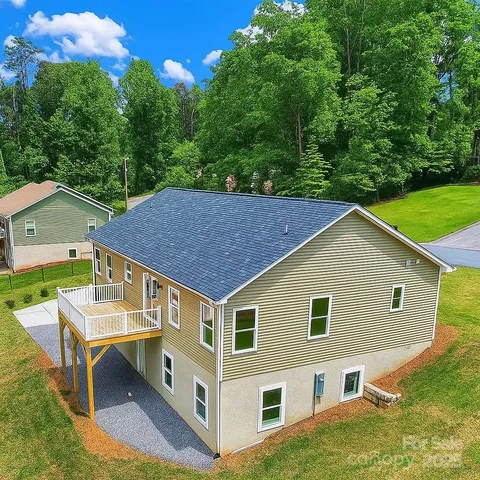 a aerial view of a house with yard and deck