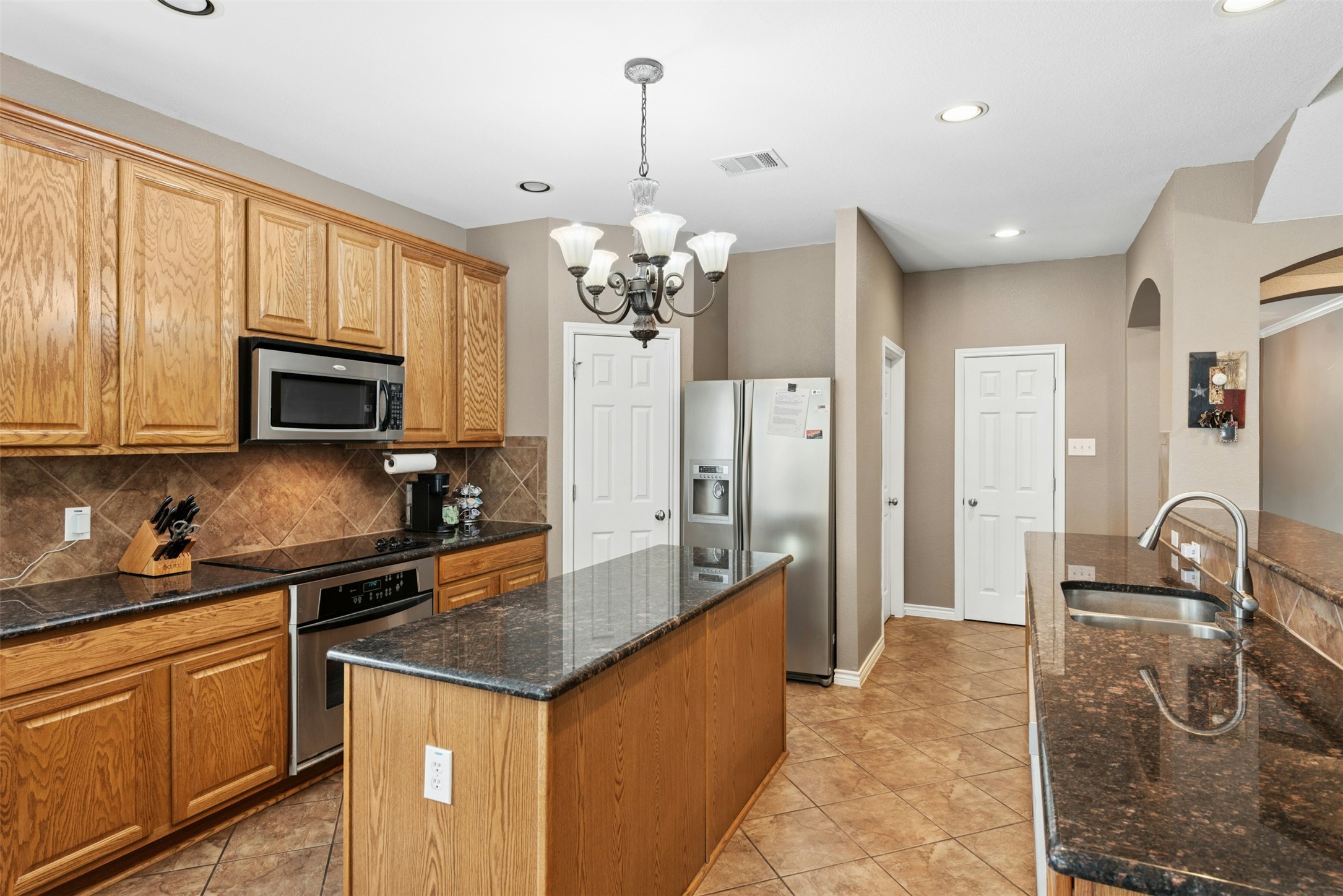30013 Edgewood Drive Georgetown, TX 78628 - Photo 11 of 39 Large center island for food prep or serving. Ample cabinets and counter space and Walk-in Pantry