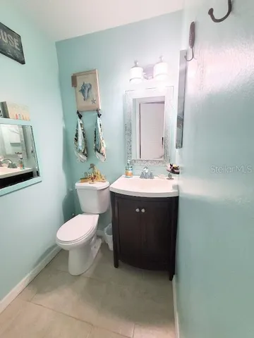 a spacious bedroom with a bed a dresser and wooden floor