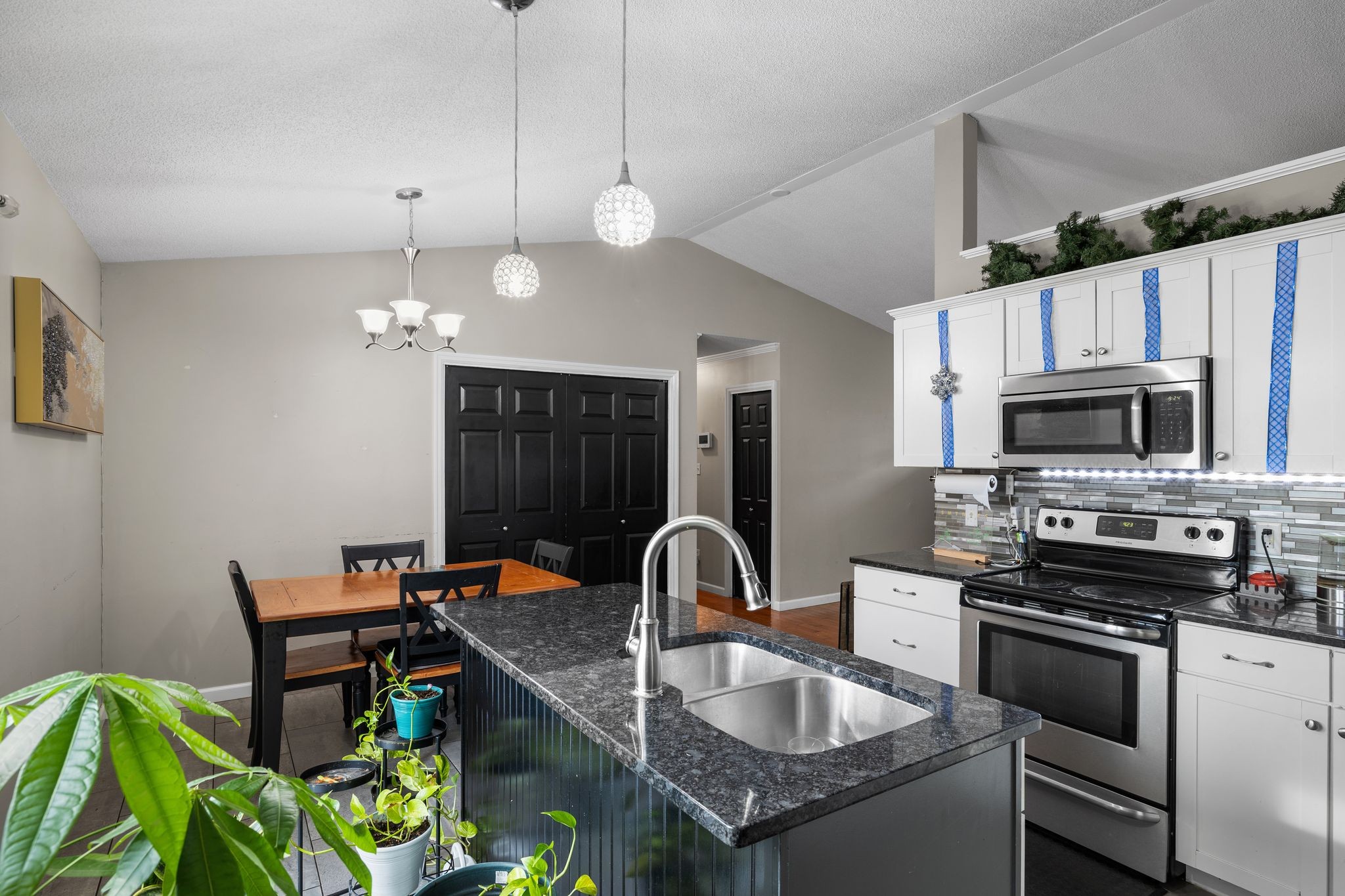 1516 Richmond Road Columbia, TN 38401 - Photo 12 of 26 a kitchen with stainless steel appliances granite countertop a sink a stove and a microwave