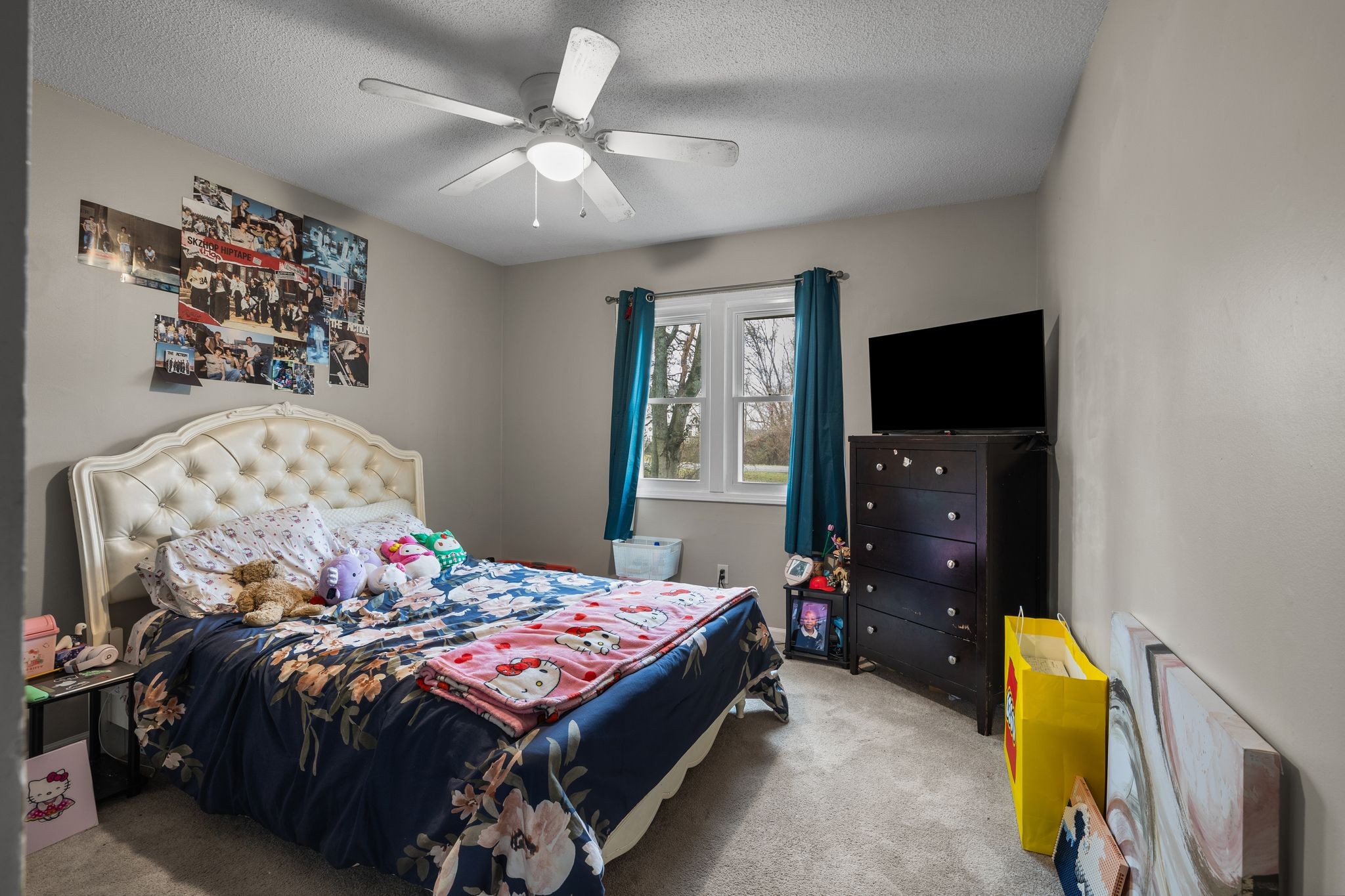 1516 Richmond Road Columbia, TN 38401 - Photo 18 of 26 a bedroom with a bed dresser and a flat tv screen