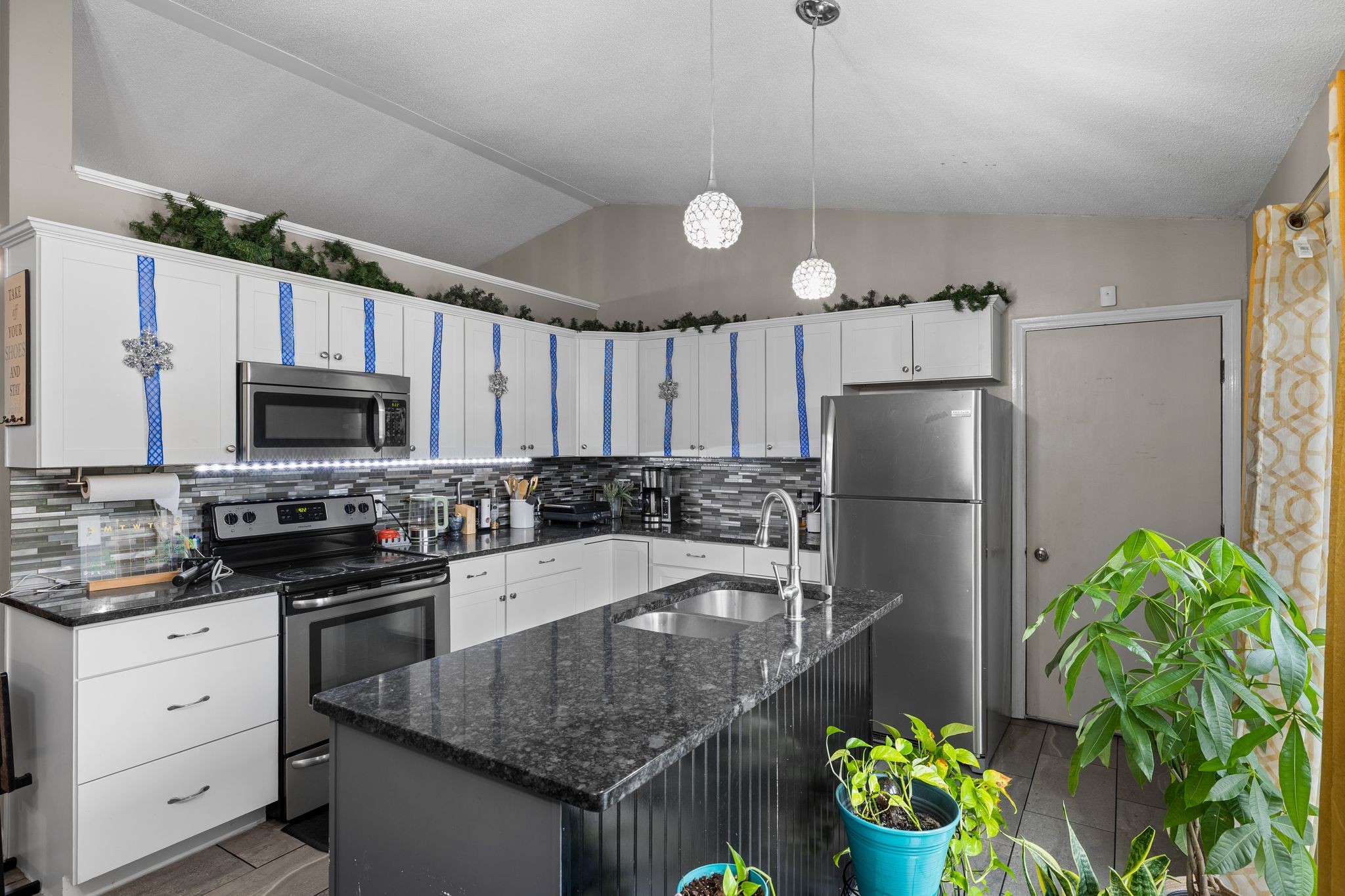 1516 Richmond Road Columbia, TN 38401 - Photo 10 of 26 a kitchen with stainless steel appliances granite countertop a refrigerator a stove a sink a microwave a dining table and chairs with wooden floor
