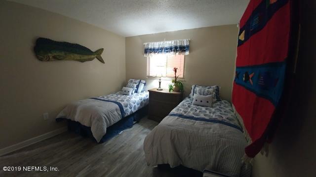 4 Ocean Trace Road, Unit 108 St. Augustine, FL 32080 - Photo 14 of 21 a bed sitting in a bedroom next to a window