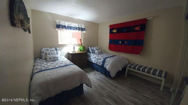 4 Ocean Trace Road, Unit 108 St. Augustine, FL 32080 - Photo 15 of 21 a bedroom with two beds and a potted plant