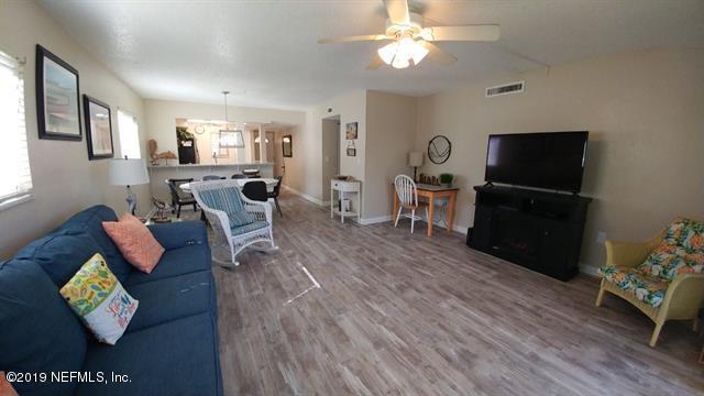4 Ocean Trace Road, Unit 108 St. Augustine, FL 32080 - Photo 3 of 21 a living room with furniture and a flat screen tv