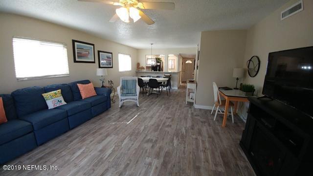 4 Ocean Trace Road, Unit 108 St. Augustine, FL 32080 - Photo 4 of 21 a living room with furniture and a wooden floor