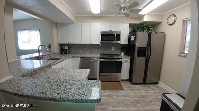 4 Ocean Trace Road, Unit 108 St. Augustine, FL 32080 - Photo 5 of 21 a kitchen with stainless steel appliances granite countertop a refrigerator a stove and a sink