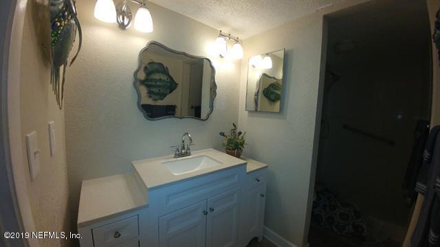 4 Ocean Trace Road, Unit 108 St. Augustine, FL 32080 - Photo 8 of 21 a bathroom with a sink and a mirror