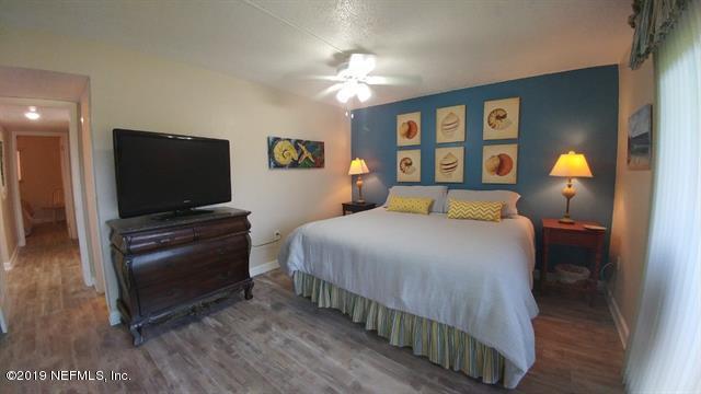 4 Ocean Trace Road, Unit 108 St. Augustine, FL 32080 - Photo 10 of 21 a bedroom with a bed and a flat screen tv