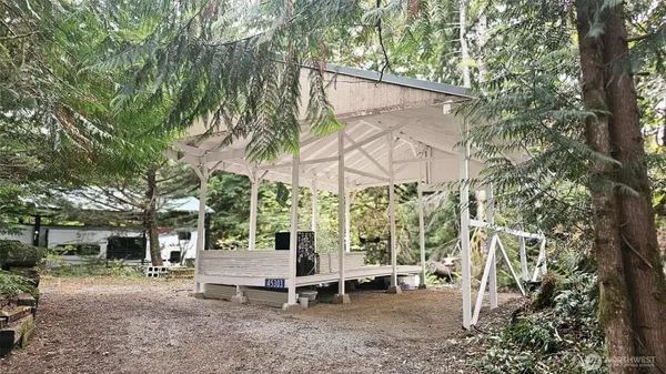 a view of a chair and table in backyard of the house