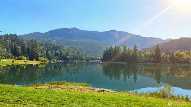 a view of a lake in a town with mountains in the background