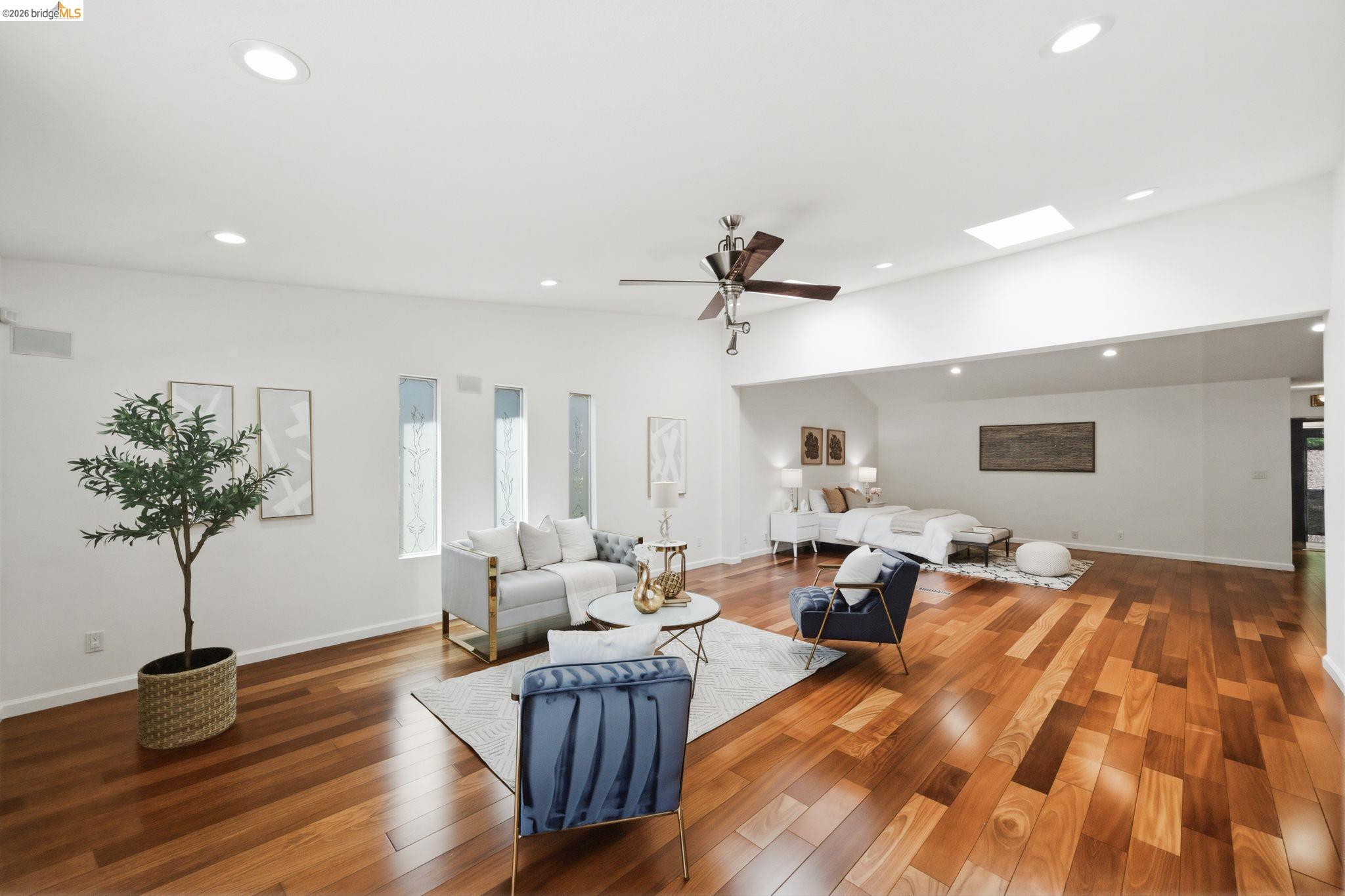 11133 Golf Links Road Oakland, CA 94605 - Photo 27 of 57 Open-concept interior featuring rich wood-finish flooring, vaulted ceilings, recessed lighting, a skylight, and transom windows