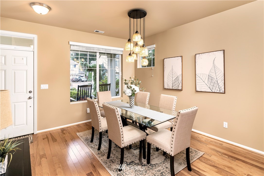 3801 219th Place Southeast Bothell, WA 98021 - Photo 2 of 22 a dining room with furniture a chandelier and wooden floor