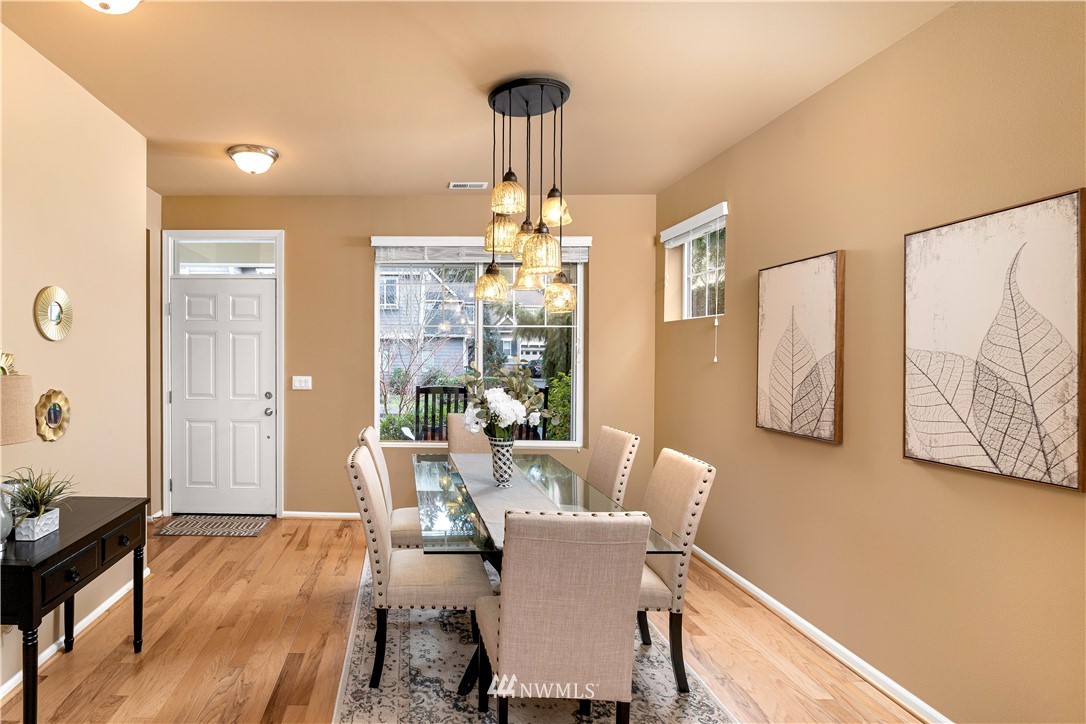 3801 219th Place Southeast Bothell, WA 98021 - Photo 3 of 22 a view of a dining room with furniture wooden floor and a chandelier
