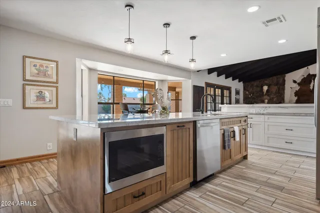 a kitchen with stainless steel appliances granite countertop a stove and a sink