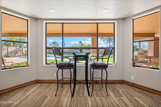 a dining room with furniture water view and wooden floor