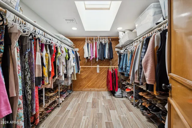 a view of walk in closet with clothes