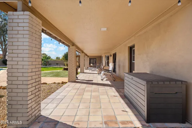 a view of a patio with dining table and chairs