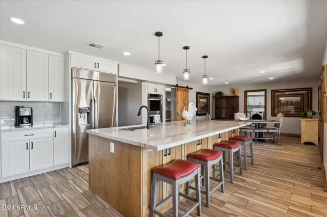 a large kitchen with lots of counter space and stainless steel appliances