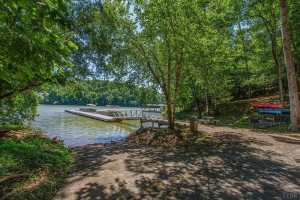 a view of a lake with trees and houses in the back
