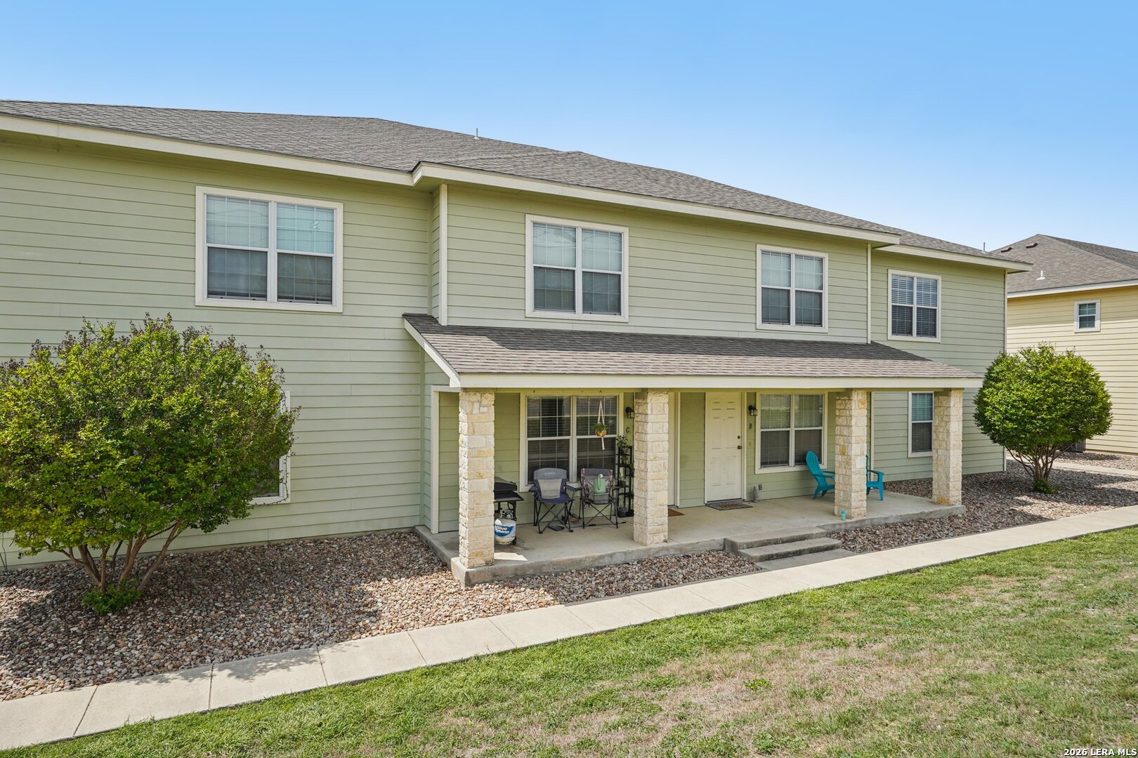 a view of a house with backyard porch and garden