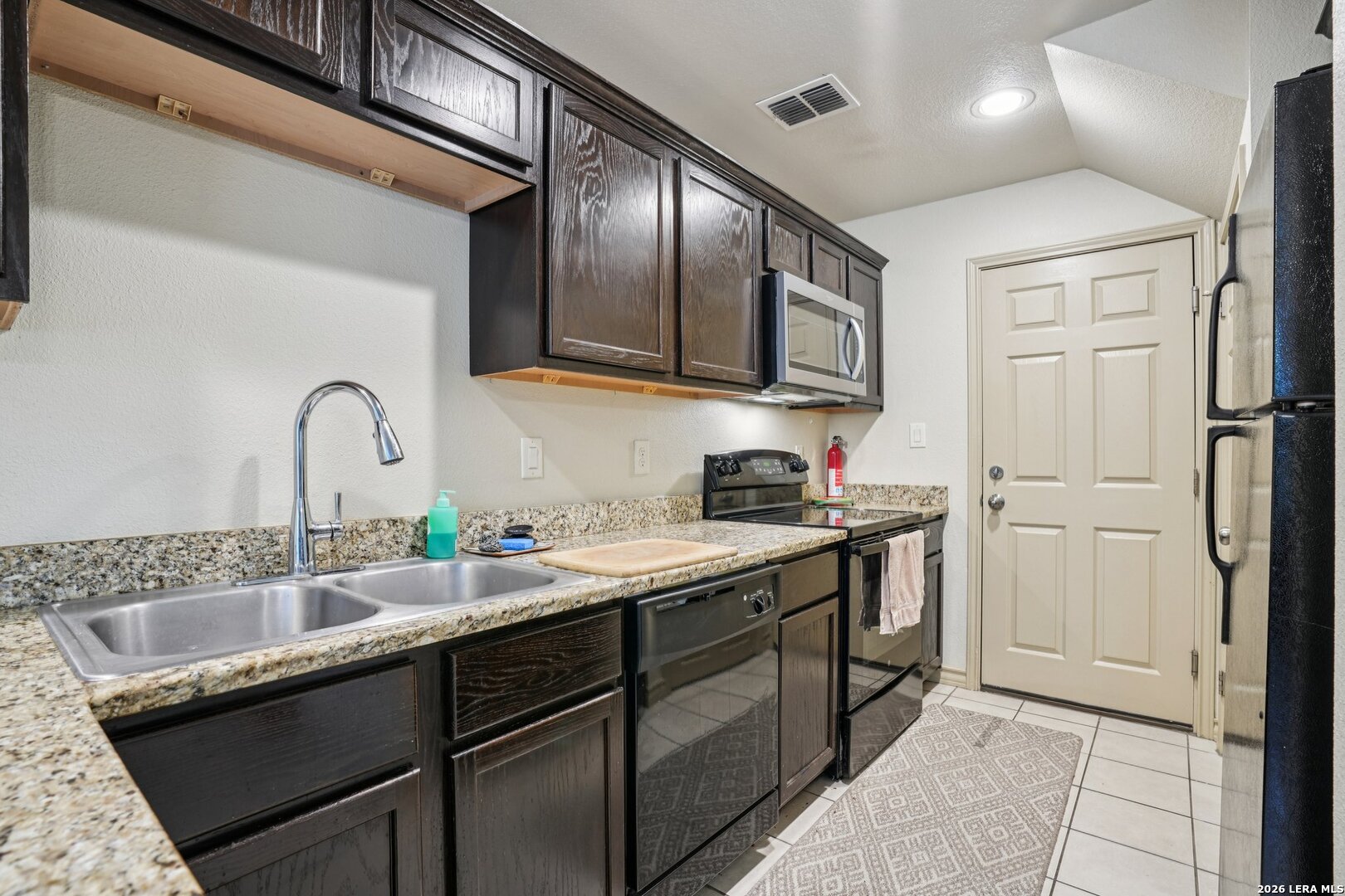 2312 Sailing Way, Unit A Kerrville, TX 78028 - Photo 11 of 29 a kitchen with a sink cabinets and stainless steel appliances