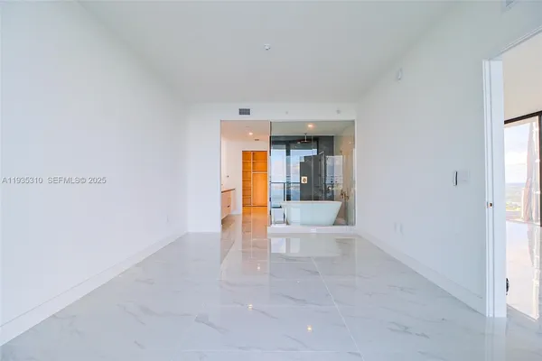 a white bath tub sitting in a en suite bathroom