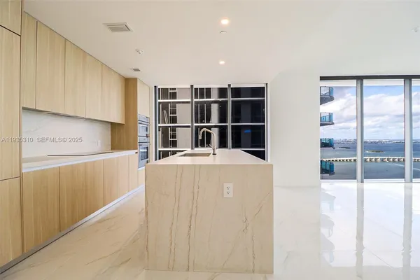 a kitchen with cabinets and a refrigerator